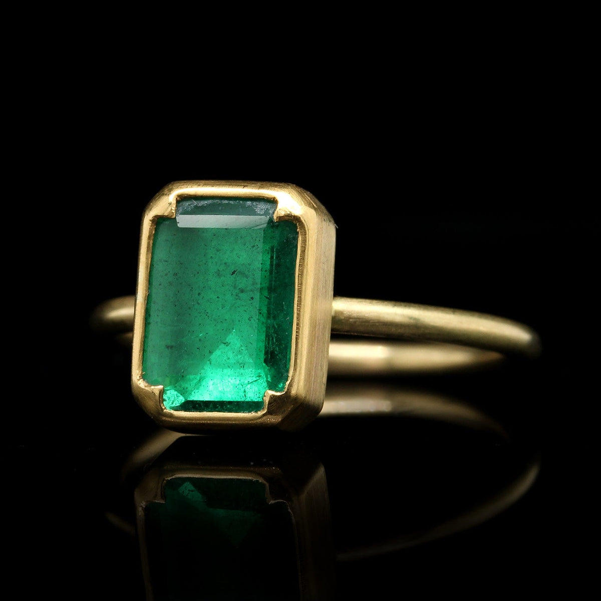 Petra Class Oval Bezel Set Faceted Emerald Ring | Quadrum Gallery